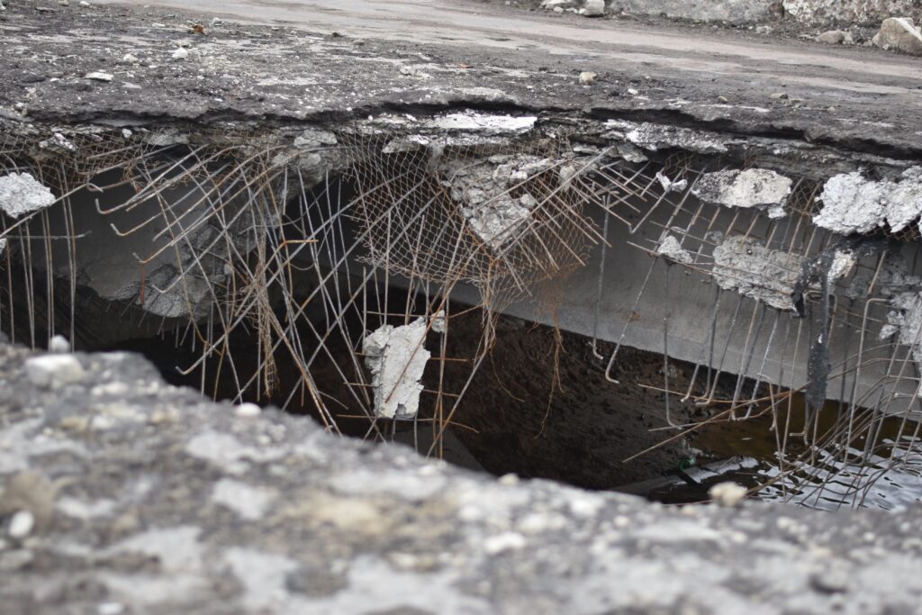 Sinkholes in Orlando expose collapsed pavement and rebar over a ground cavity